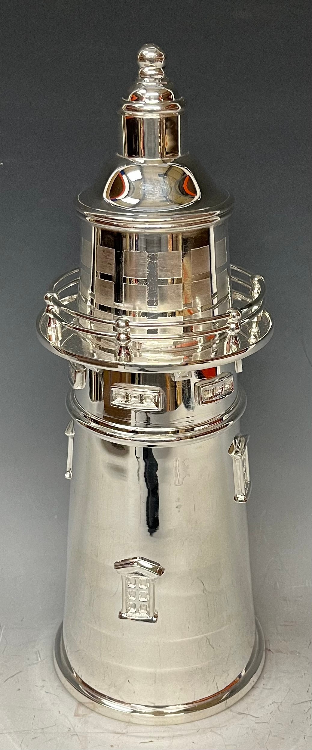 An Art Deco style silver plated novelty cocktail shaker, as a lighthouse, stamped mark to base, 34cm
