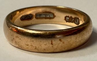 A gold wedding band, size O, marks obscured, probably 18ct, 4.5g