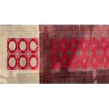A Middle Eastern woolen rug or carpet, worked with geometric motifs, in tones of red and black,
