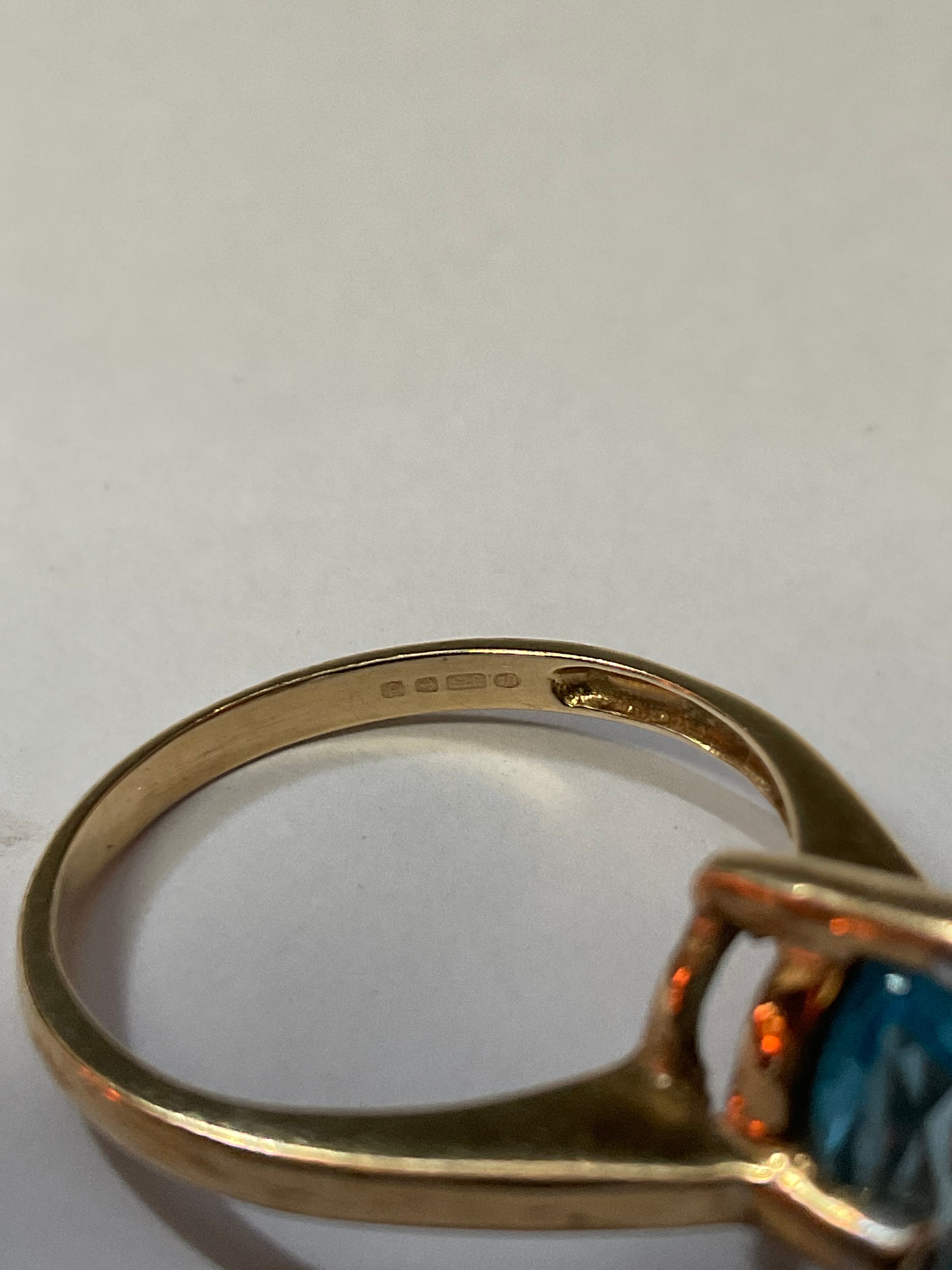 A 9ct gold ring, set with a central faceted topaz, surrounded by four illusion set diamond chips, - Image 3 of 4