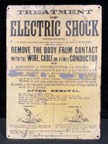 A rounded rectangular shaped tin pictorial wall sign, 'TREATMENT OF ELECTRIC SHOCK', 50.5cm high,