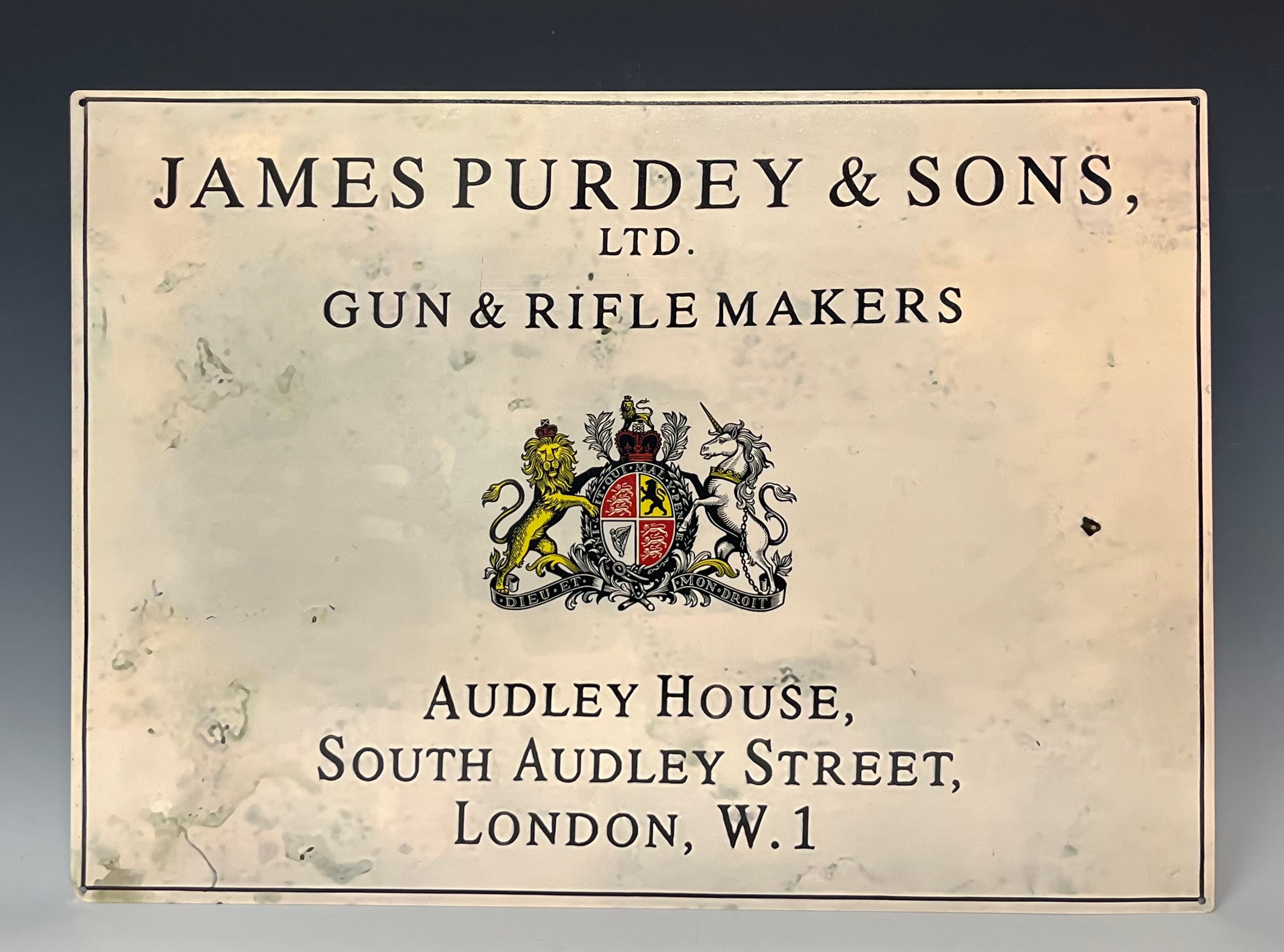 A reproduction tin Advertising sign, James Purdey & Sons Ltd, Gun & Rifle Makers, Audley House,