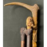Walking Sticks - an early 20th century walking stick, the naturalistic shaft carved with leaves