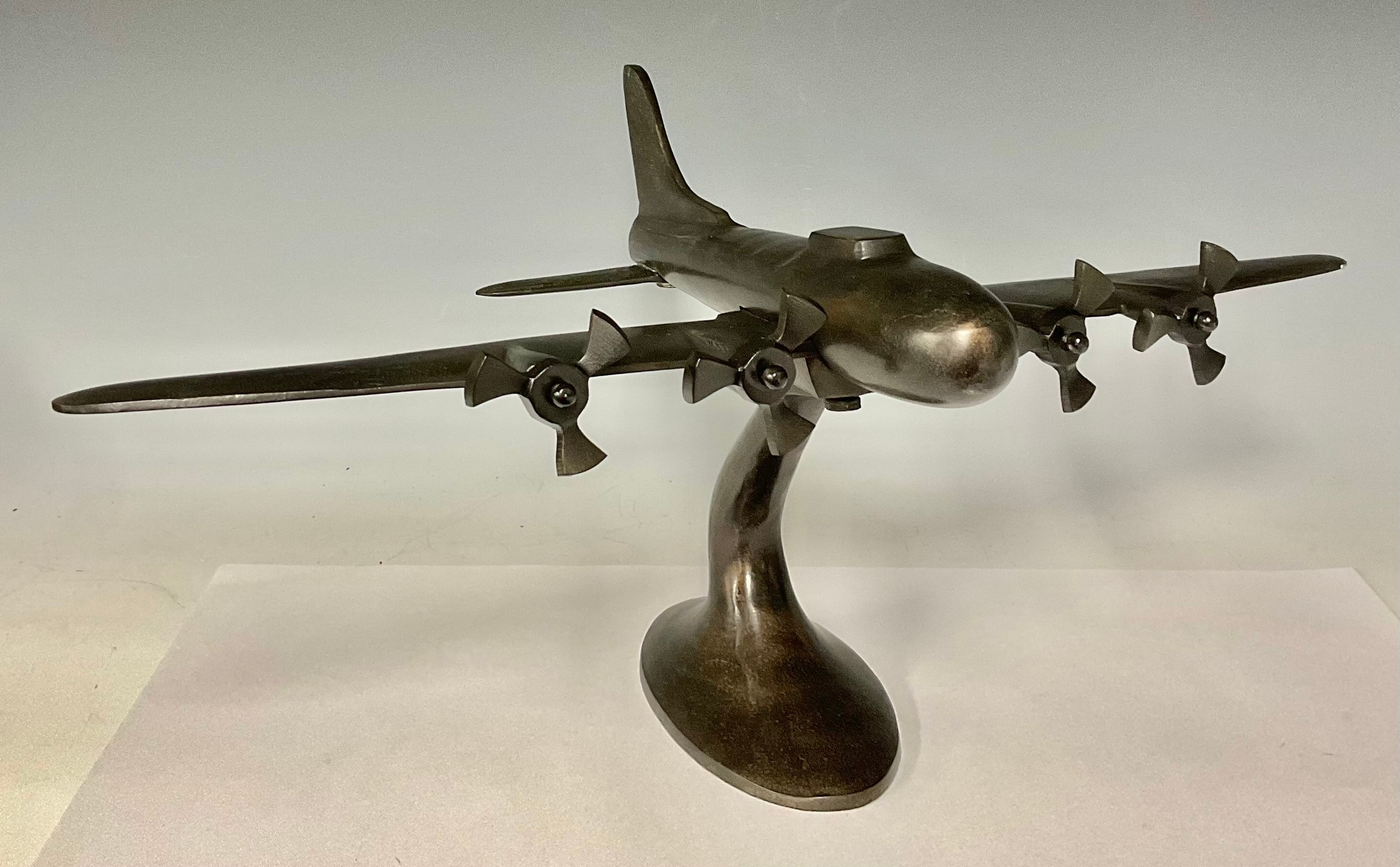 A bronzed model aeroplane on stand, 27cm high, 33cm long