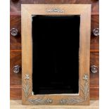 An Art Nouveau style oak mirror, the border decorated with irises, 60cm x 35cm