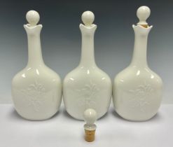 A set of three Royal Copenhagen decanters and stoppers, glazed throughout in gloss white, number