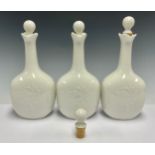 A set of three Royal Copenhagen decanters and stoppers, glazed throughout in gloss white, number