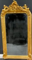 A Louis XIV style rounded rectangular gilt-wood effect mirror, 'baroque' cresting flanked by