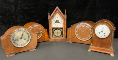 A late 19th century American architectural mantel clock, arched pediment, white dial with Roman