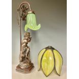 A table lamp, the resin figural base as a young boy with dog companion, opaque tulip shaped shade in