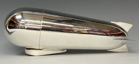A reproduction silver plated cocktail shaker, modelled as a Zeppelin, 24cm high