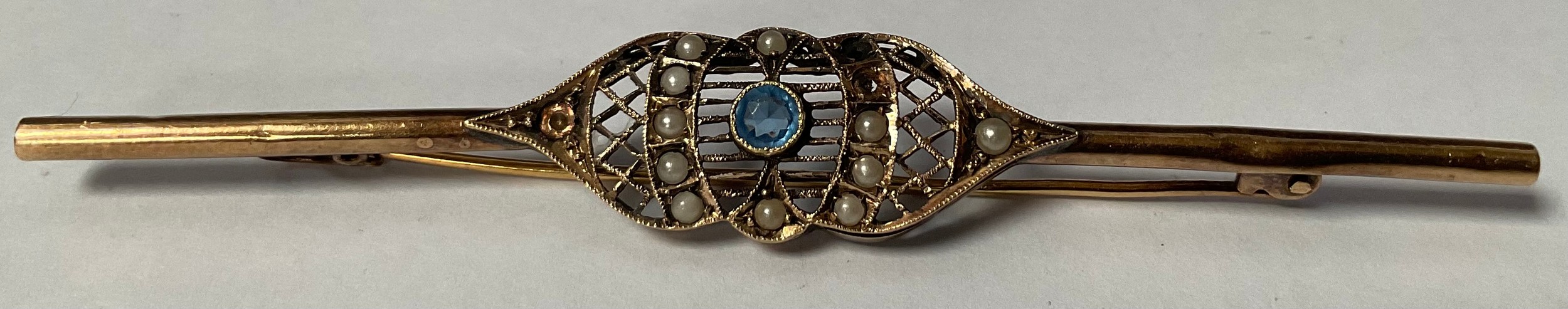 A late 19th/early 20th century bar brooch, set with seed pearls and blue central stone, unmarked, 4g