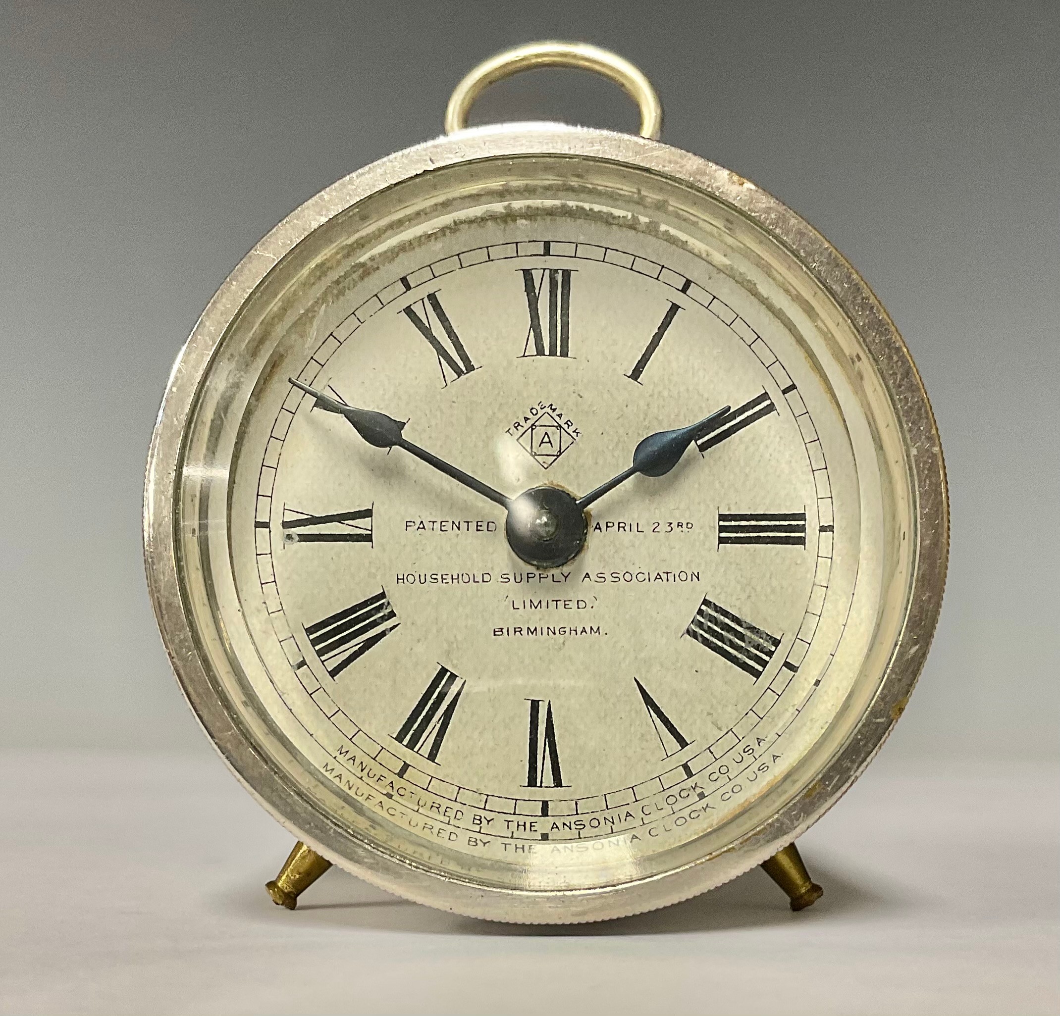 A drum shaped "Train" alarm clock, white dial with Roman numerals, patent Ansonia Clock Co. USA,