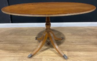 A Regency style breakfast or dining table, oval tilting top, 76cm high, 140cm long, 92cm wide