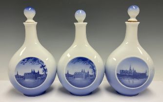 A set of three Royal Copenhagen compressed ovoid bottle vases and covers, two printed with