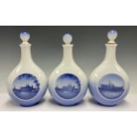 A set of three Royal Copenhagen compressed ovoid bottle vases and covers, two printed with