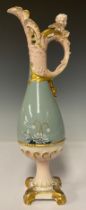 A Royal Dux ewer, pierced spout glazed in pink, loop handle with cherub mask thumbpiece, applied