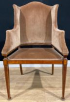 An Edwardian satinwood banded mahogany wing chair, stuffed-over upholstery, tapered square forelegs,