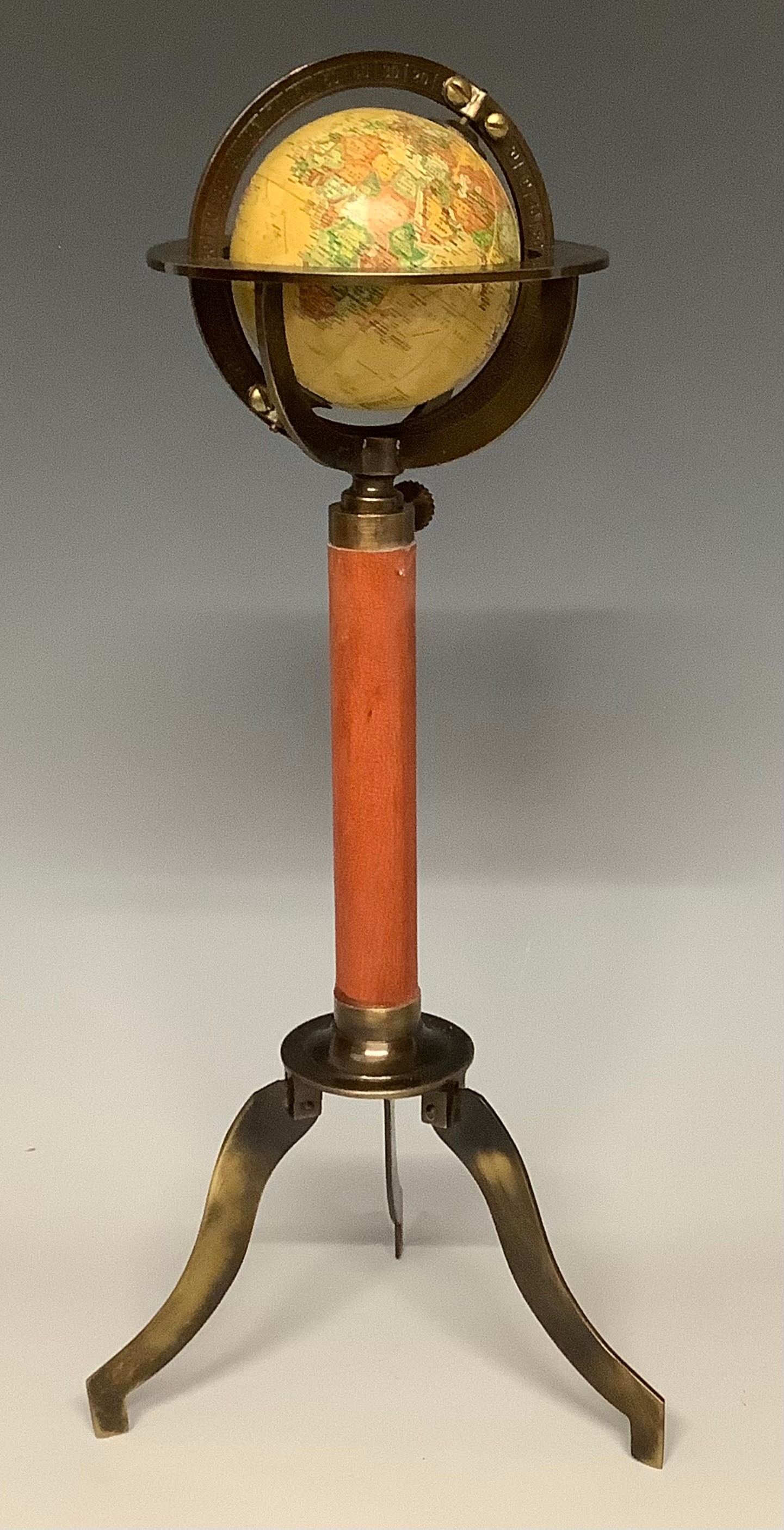 A reproduction miniature desktop globe, with leather bound support, tripod base, 29cm high