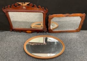 A George II Revival mahogany Vauxhall looking glass, carved eagle cresting, shaped apron inlaid with
