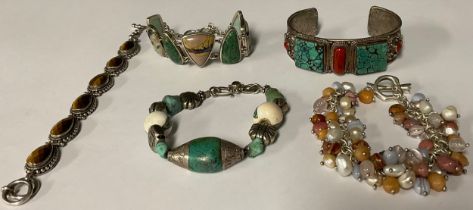 A sterling silver QVC bracelet set with seven polished specimen stones, marked 925; a sterling