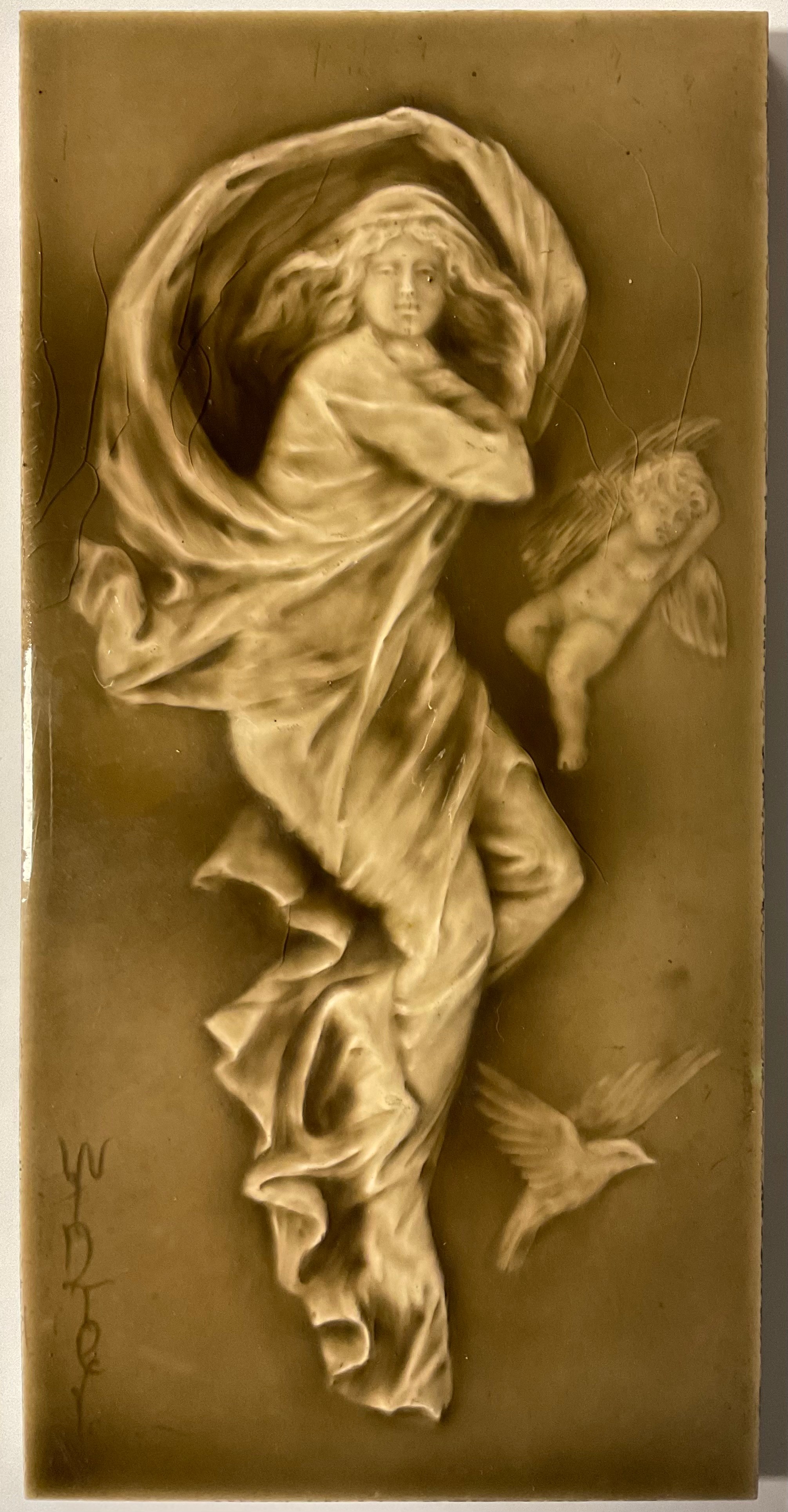 Ceramics - an Art Nouveau tile, lady with dove and putto, entitled ‘Winter’, 30cm x 15cm