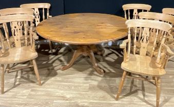 A farmhouse pine circular dining table, 72cm high, 151.5cm diameter; a set of seven beech carver
