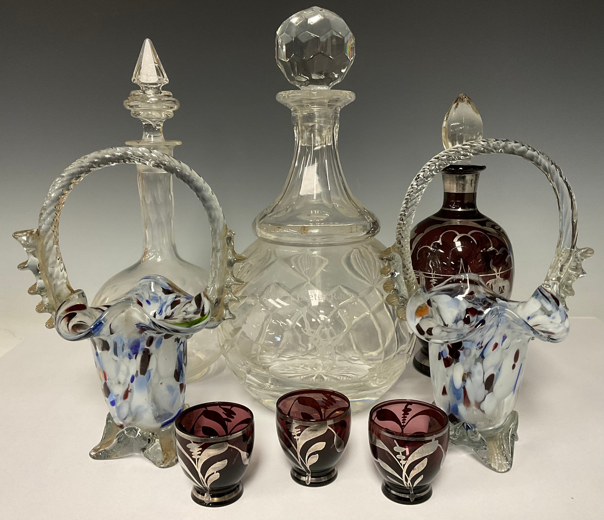 Glass - two coloured glass baskets; a silver overlaid decanter and glasses; a large cut glass