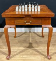 A contemporary games table, removable square top inlaid for chess, the verso with baize, enclosing a