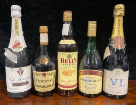 A bottle of Bell's Scotch whisky; others, Hennessy Cognac; Martini Asti-Spumante; Napoleon Brandy;