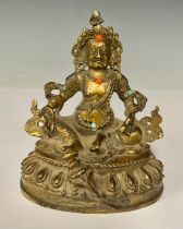 A gilt metal model of a Deity, inset with coral and turquoise, 12.5cm high