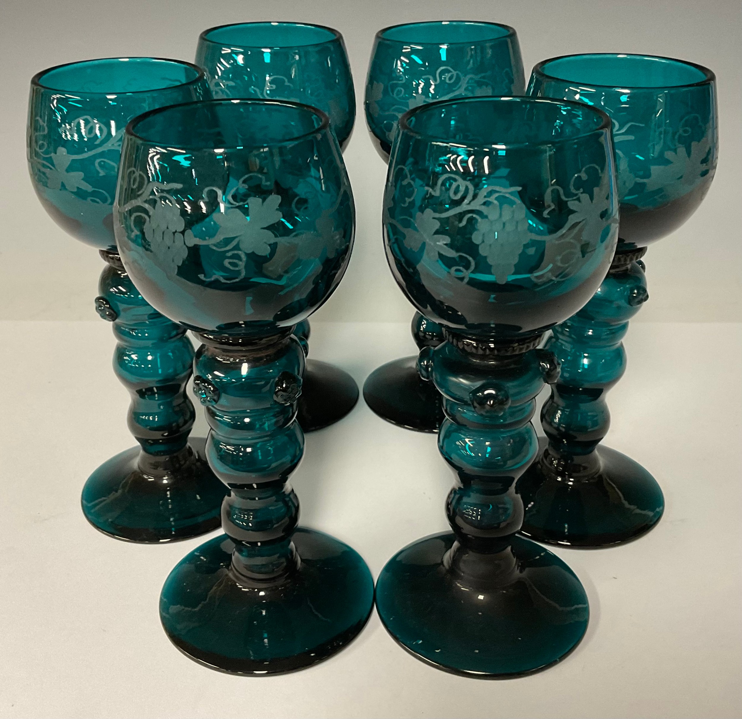 A set of six 19th century turquoise glass wine roamers, ovoid bowls etched with fruiting vine,