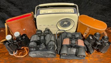 Four cased sets of binoculars; a vintage Bush transistor radio