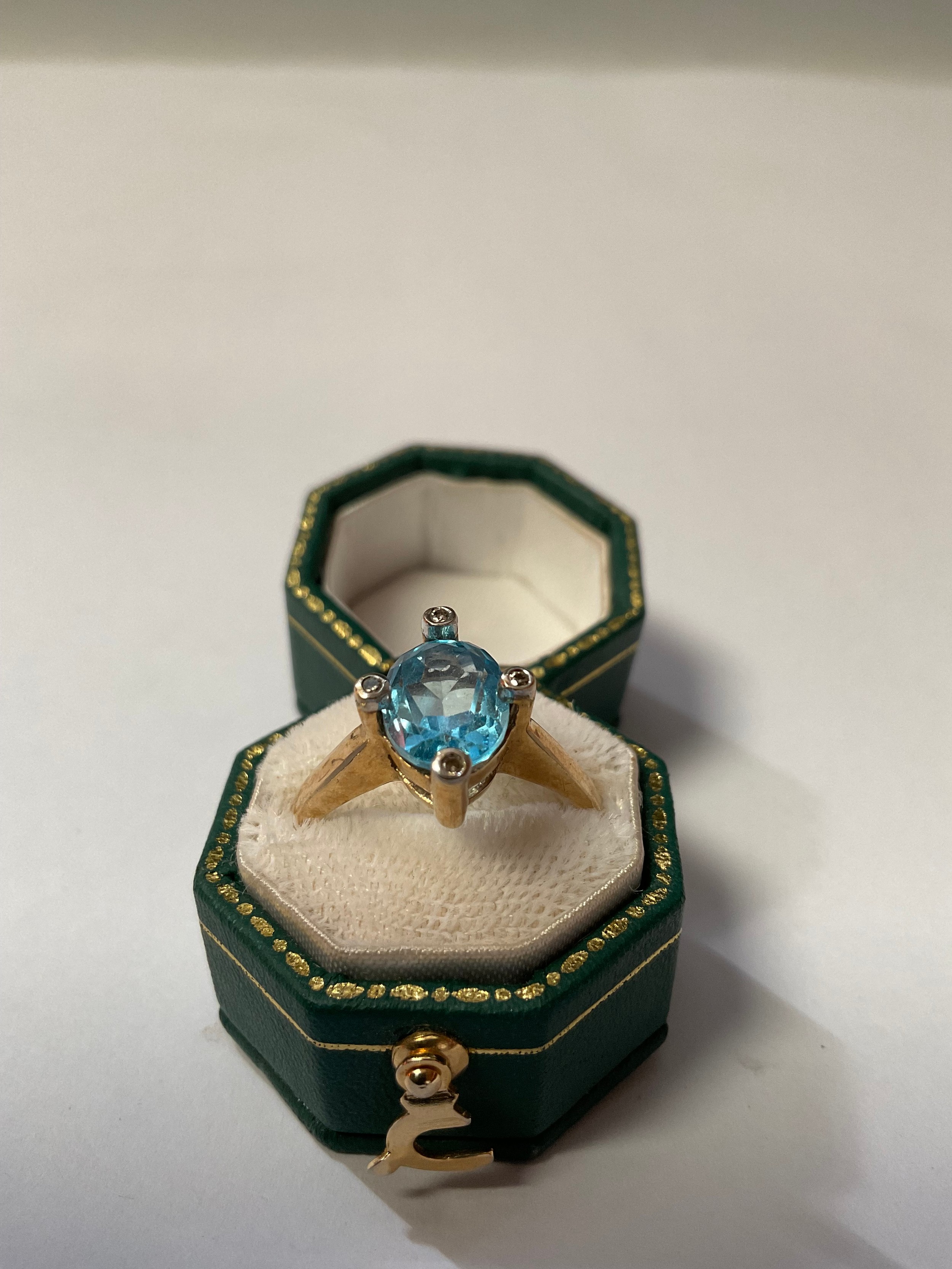 A 9ct gold ring, set with a central faceted topaz, surrounded by four illusion set diamond chips, - Image 4 of 4