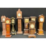 Clocks - an Edwardian mahogany miniature longcase clock, Roman numerals on white enamel dial,