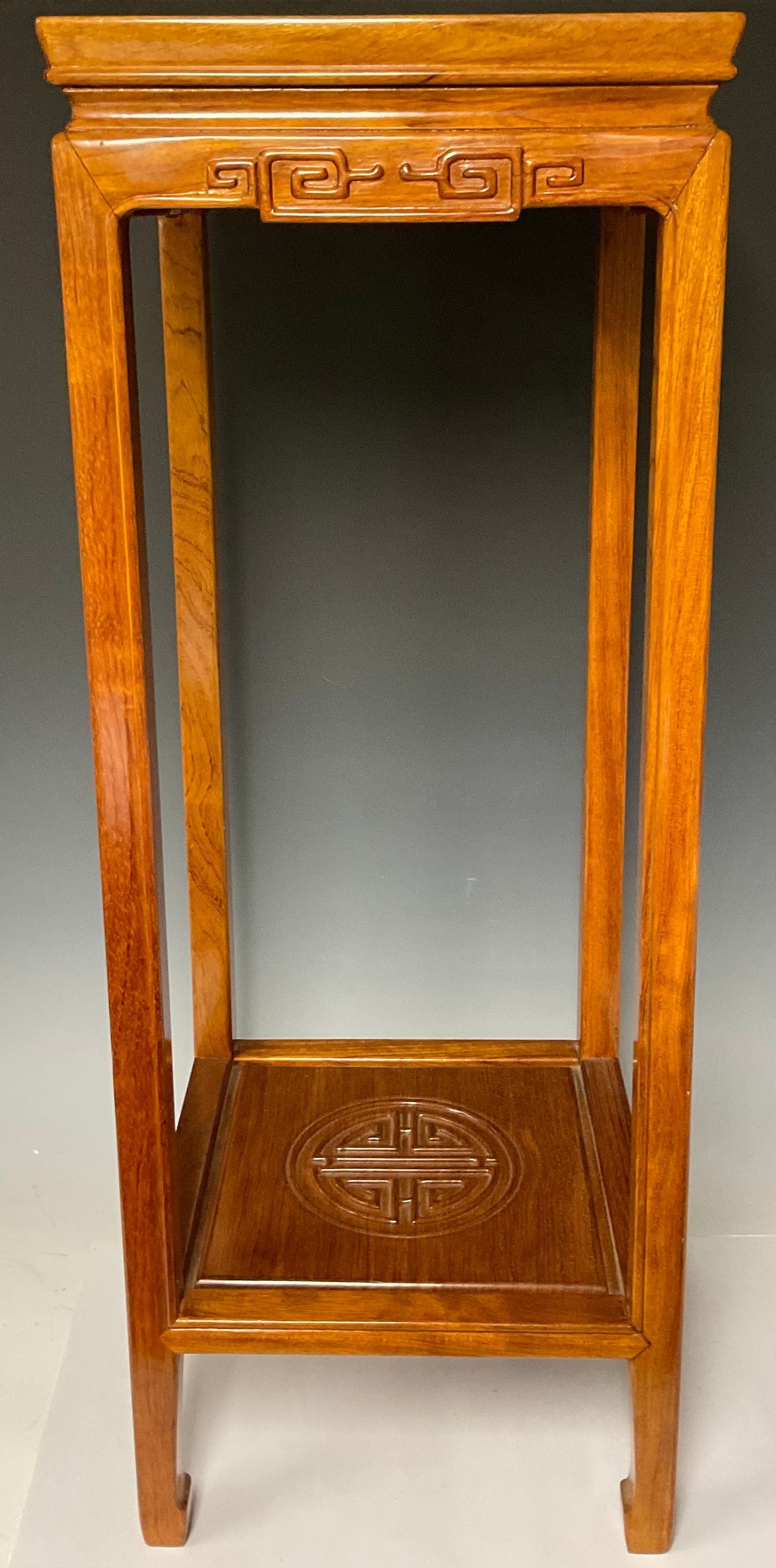 A Chinese hardwood stand, 81cm high, 31cm wide, 31cm deep