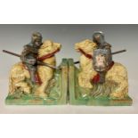 A pair of terracotta bookends as medieval jousting knights on horseback, gloss glazed in shades of