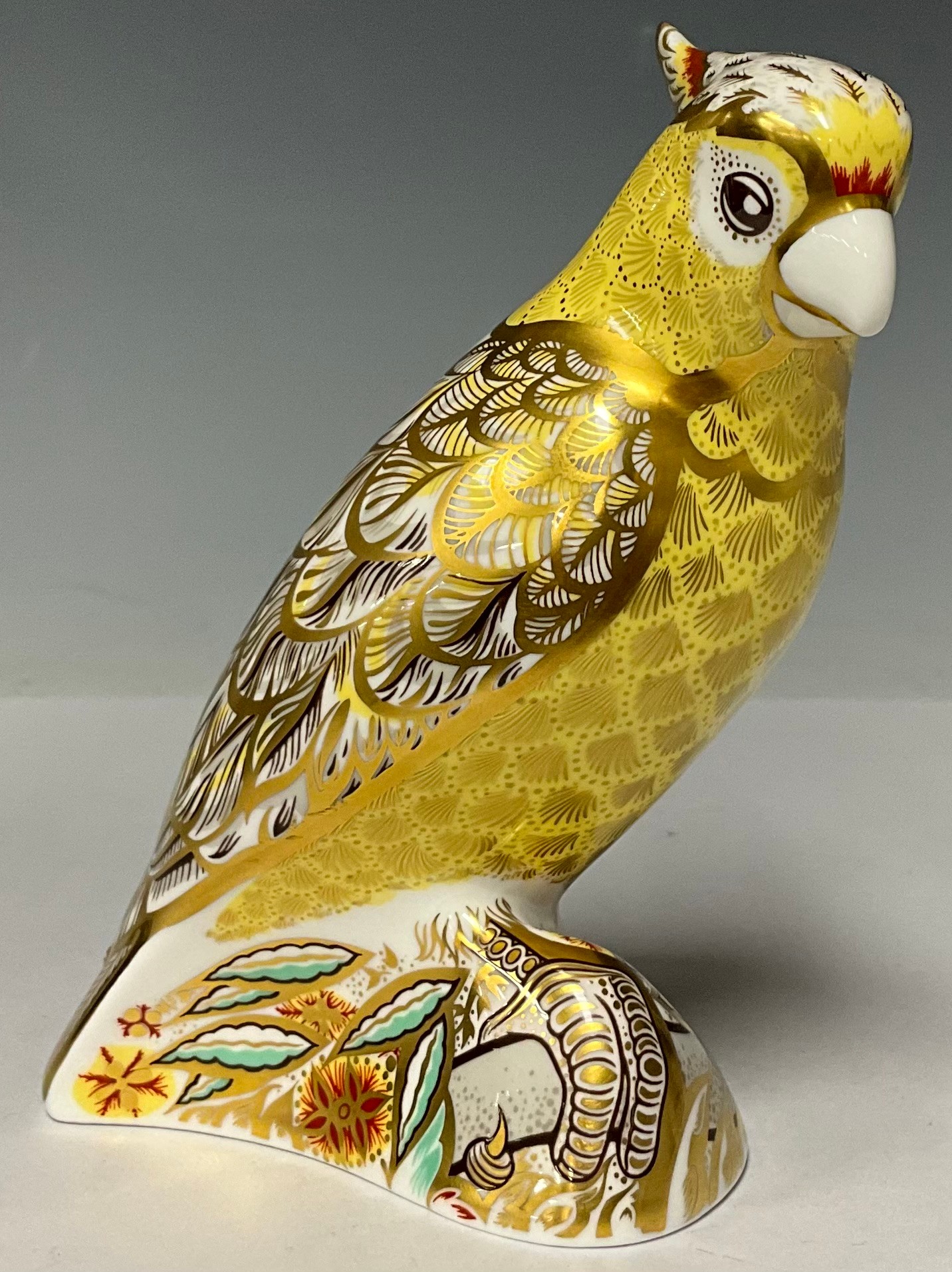 A Royal Crown Derby paperweight, Citron Cockatoo, gold stopper, 13cm high, red printed marks and