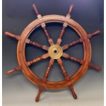 A contemporary hardwood and brass stained ship's wheel, approx. 91.5cm wide