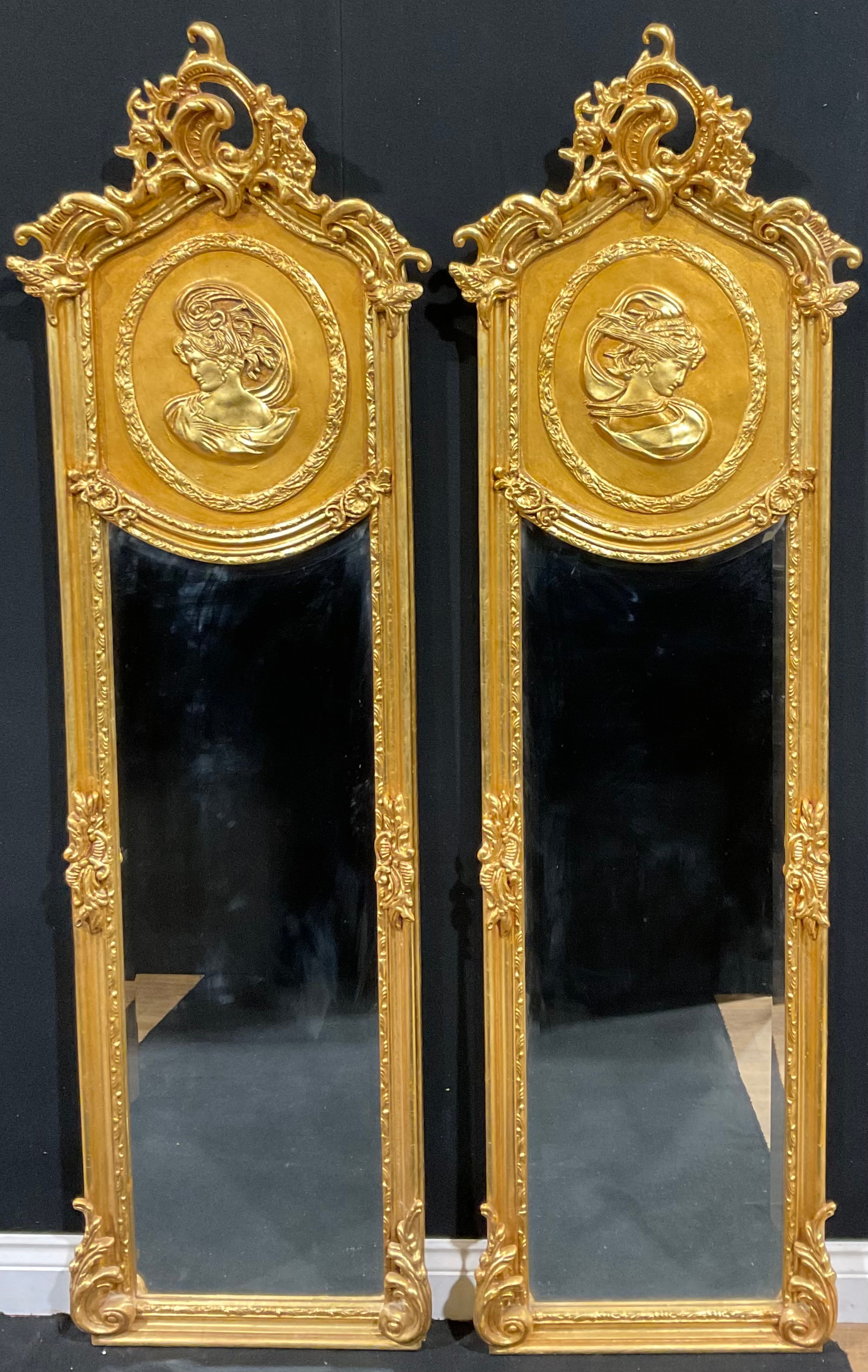 A pair of contemporary Italian Baroque style gilt wall hanging mirrors, each with interlaced foliate