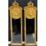 A pair of contemporary Italian Baroque style gilt wall hanging mirrors, each with interlaced foliate