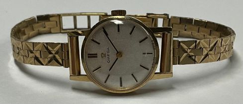 A lady's Omega 9ct gold watch, Champagne dial, baton indicators, integral 9ct gold bracelet strap,