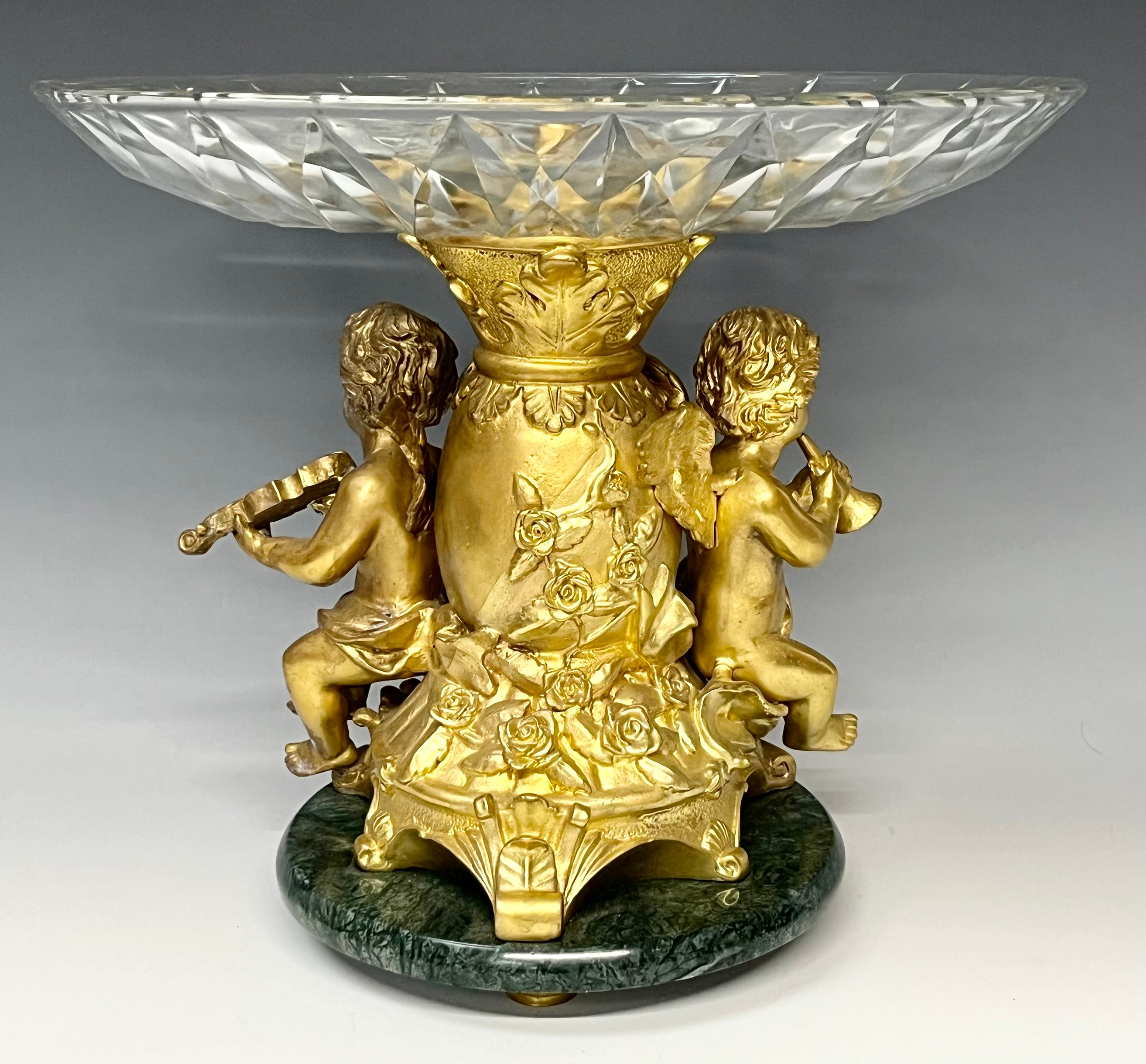 A reproduction 19th century style table centre, the gilt metal support cast as a pair of cherub - Image 3 of 3