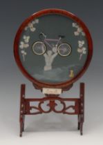 A Chinese hardwood table screen, the circular banner worked in coloured silks with a boy carrying