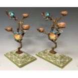 A pair of gilt metal tree stands with hand painted porcelain birds perched on the tree, faux mark,