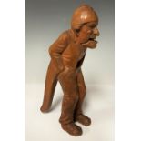 A late 19th century Swiss nutcracker, as a standing gentleman in nightcap, hands in his pockets, the