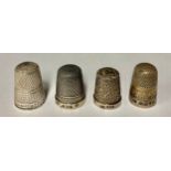 A hallmarked silver Charles Horner thimble; Good Wishes from East Barnett thimble; two other