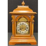 An early 20th century walnut bracket type mantel clock, Roman numerals on silvered chapter ring,