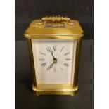 A lacquered brass carriage clock, Rapport, London, white dial with Roman numerals, 13.5cm high