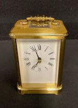 A lacquered brass carriage clock, Rapport, London, white dial with Roman numerals, 13.5cm high